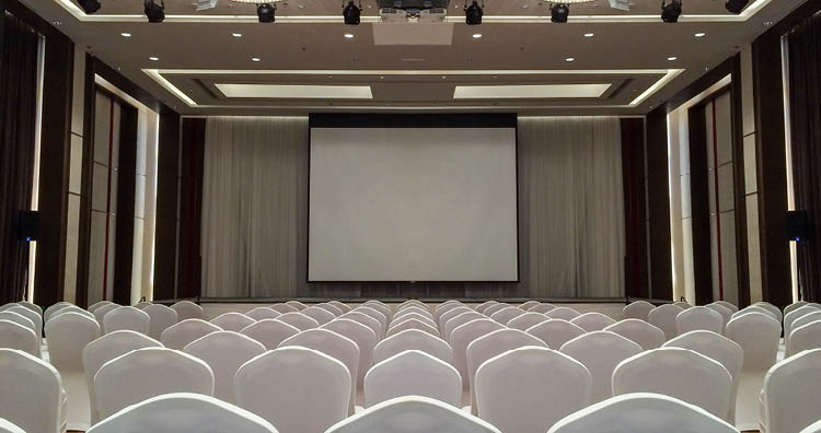 Conference Meeting Room with ceiling LED lights, Row of White Chairs, with Stage and Empty Screen for Business Meeting, Conference, Training Course, used as Template of The Elegant Design Office