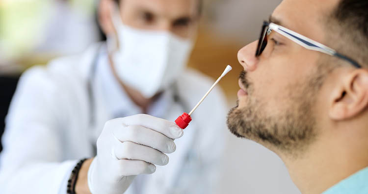 Close-up of young man getting PCR test at doctor's office during coronavirus epidemic  