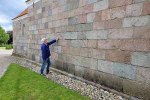 The author examining a church stone wall