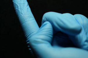 Photo of the spectrometer chip on a gloved finger