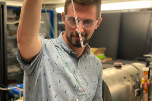 Photo of Danila Barskiy holding an NMR tube