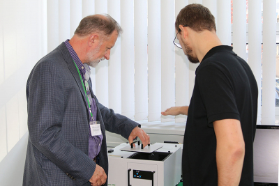 Professor Zygmunt “Karol” Gryczynski (left) examining the FluoTime 250.