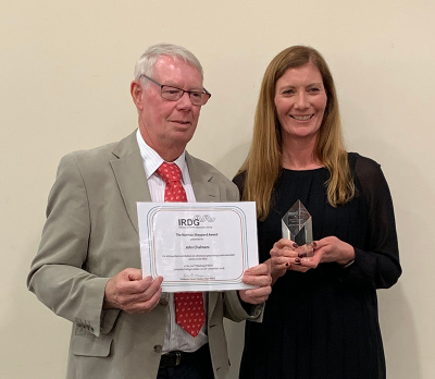 Photo of John Chalmers receiving the Award from Karen Faulds