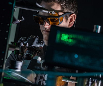 Rice University graduate student Kyle Smith checks a sample while testing the lab’s snapshot hyperspectral imaging system. Rice scientists developed the system to take instantaneous spectra of multiple plasmonic nanoparticles. Credit: Jeff Fitlow/Rice University