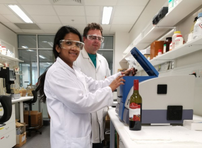 PhD student Ruchira Ranaweera loads a wine sample into a spectrofluorometer, with Associate Professor David Jeffery. Courtesy of University of Adelaide.