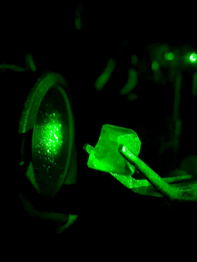 Photo of tweezers holding a crystal