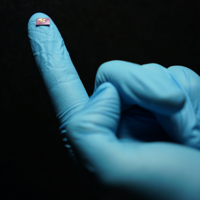 Photo of the spectrometer chip on a gloved finger