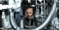 Photo of Professor Aleksander Jablonski looking through a gap in the instrument