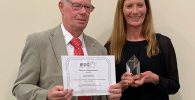Photo of John Chalmers receiving the Award from Karen Faulds