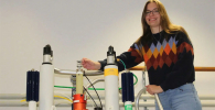 Photo of Anika Mauel on top of spectrometer magnet