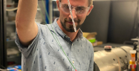 Photo of Danila Barskiy holding an NMR tube