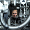 Photo of Professor Aleksander Jablonski looking through a gap in the instrument