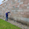 The author examining a church stone wall