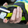 Photo of a policeman holding a breathalyser