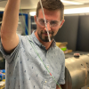 Photo of Danila Barskiy holding an NMR tube